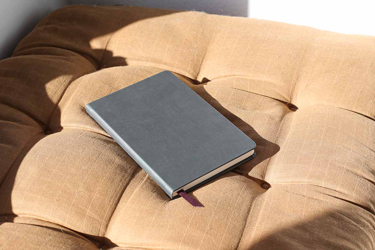 a keepbook on a cushion in the sun.