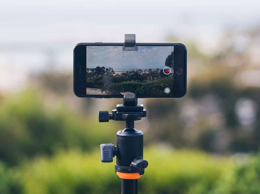 the glif on a tripod taking a photo of a landcape.