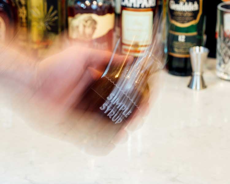 a simple syrup kit bottle being shaken