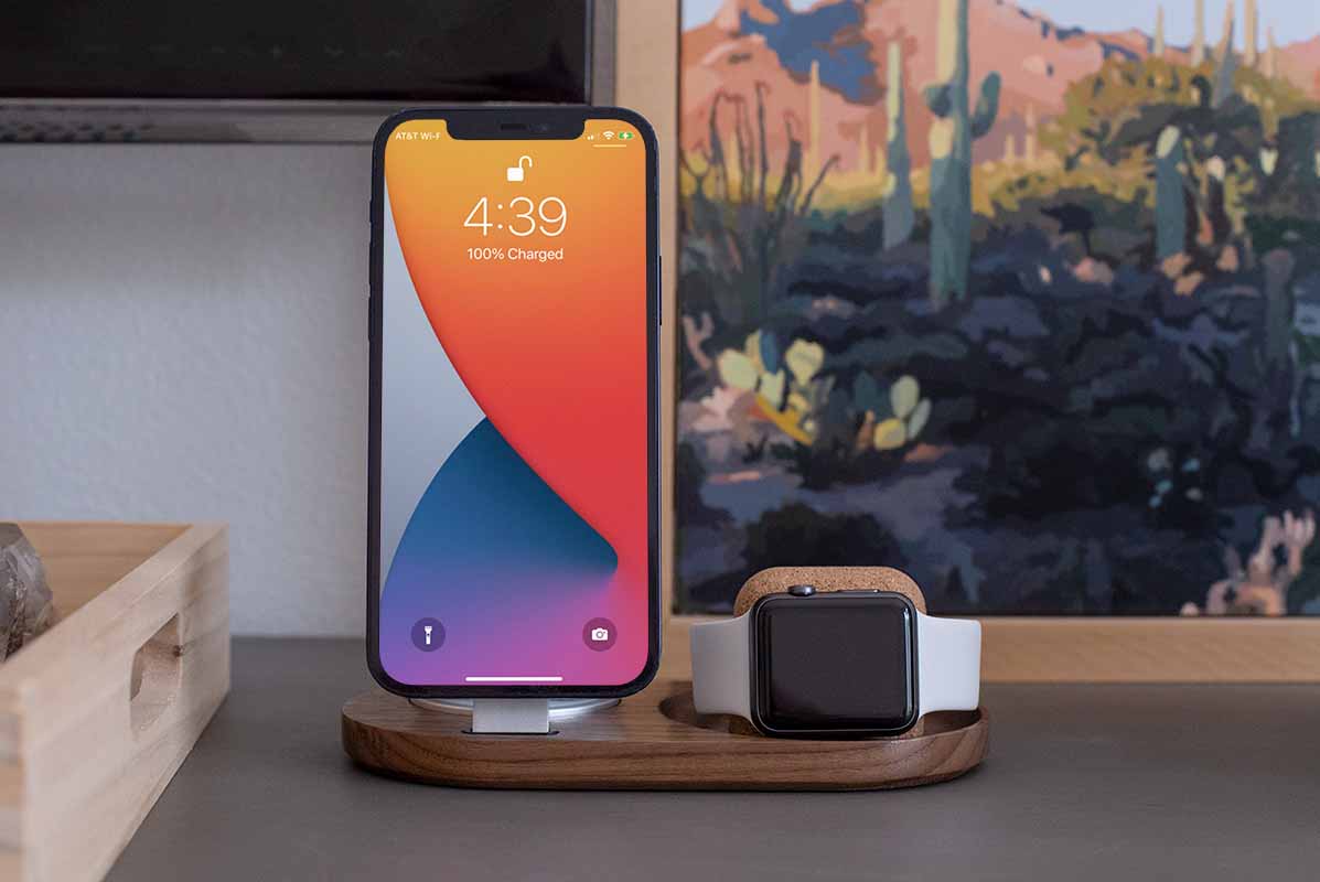 an Apple Watch and phone changing standing up on one dock.