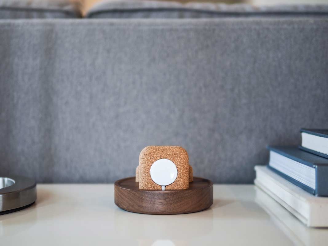 a view of the Apple Watch charging puck in the cork holder on the Material Dock.